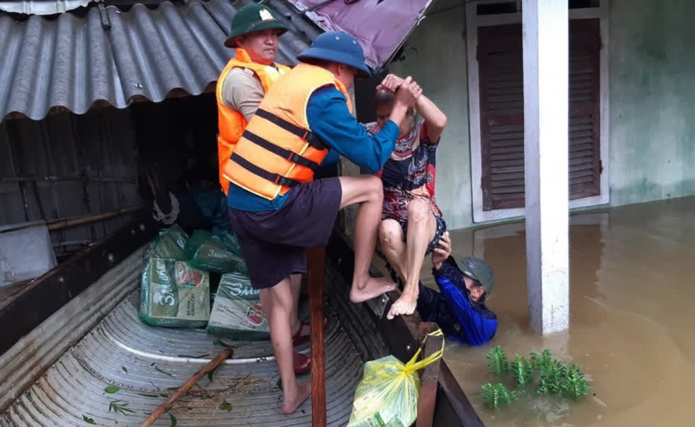 Các chiến sĩ giúp người lớn tuổi thoát khỏi ngôi nhà bị ngập nước. Ảnh: Gia đình Việt Nam