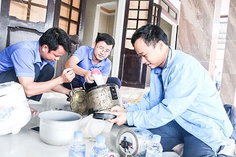 Đoàn viên, thanh niên giúp người dân sửa chữa miễn phí các thiết bị điện bị hư hại sau lũ - Ảnh: T.P​