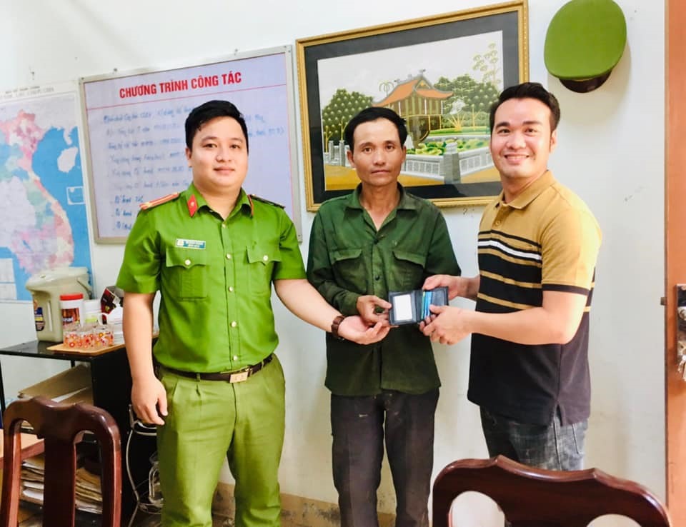 Anh Nguyễn Văn Hiển (ở giữa) cùng đại diện Công an phường Đông Lương trao trả lại tài sản cho người đánh mất - Ảnh: H.T