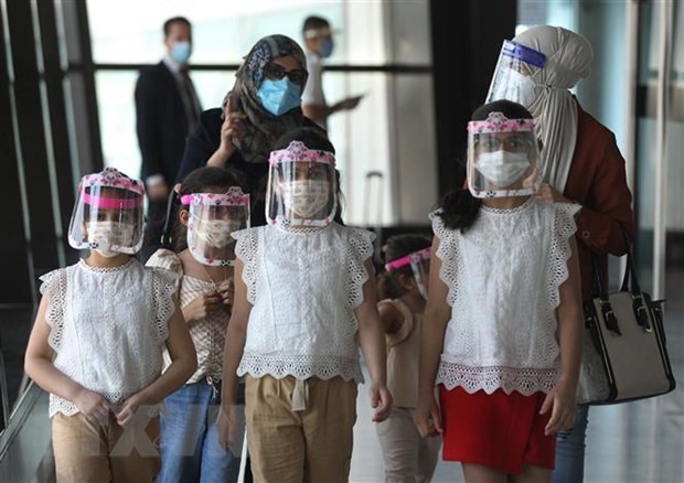 Một gia đình đeo khẩu trang phòng lây nhiễm COVID-19 tại sân bay ở Baghdad, Iraq. (Ảnh: AFP/TTXVN)