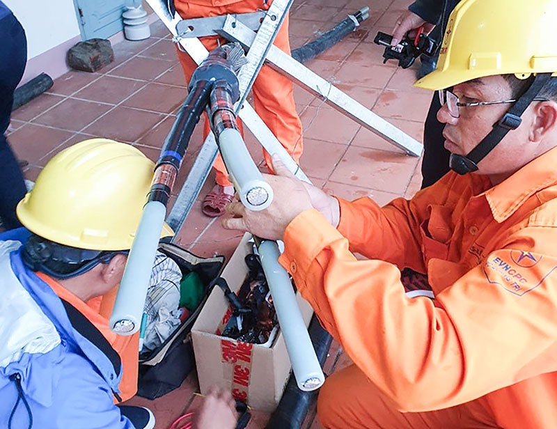 Công nhân kỹ thuật thực hành thi công đầu cáp ngầm trung áp - Ảnh: T.N