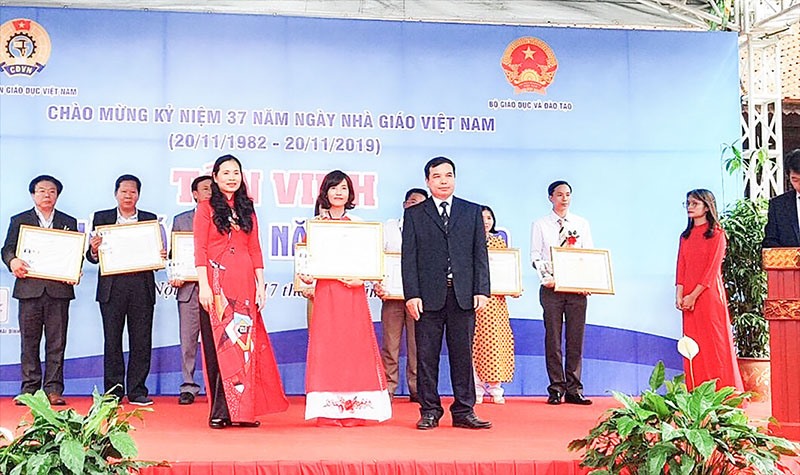 Cô Nguyễn Thị Duyên, Trường Tiểu học Hàm Nghi, TP. Đông Hà (đứng giữa) nhận bằng khen của Bộ trưởng Bộ Giáo dục và Đào tạo - Ảnh: NVCC