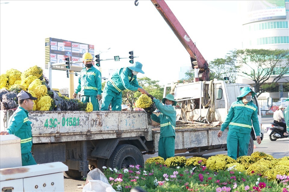 Các công nhân của công ty Công viên cây xanh đang liên tục vận chuyển hoa để trang hoàng đường phố Ảnh: LH