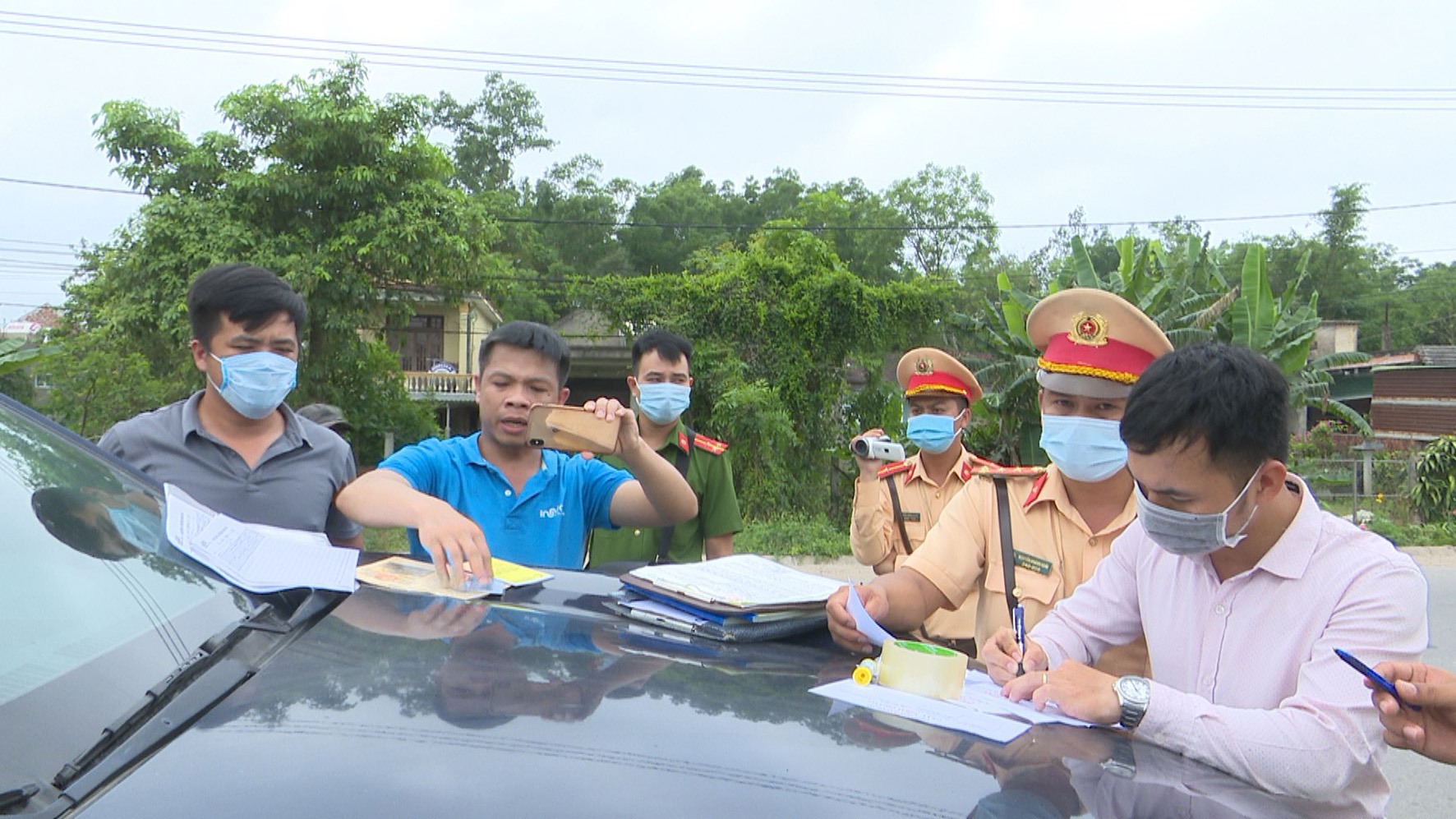 Lực lượng CSGT huyện Cam Lộ lập biên bản xử phạt đối tượng vi phạm ATGT cố thủ trong xe ô tô-Ảnh: Lê Trường