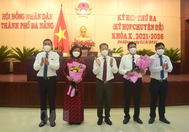 Ông Trần Phước Sơn (thứ 2 từ phải sang) và bà Ngô Thị Kim Yến (thứ 2 từ trái sang) nhận hoa chúc mừng từ các lãnh đạo Thành ủy, HĐND, UBND thành phố Đà Nẵng. (Ảnh: Quốc Dũng/TTXVN)