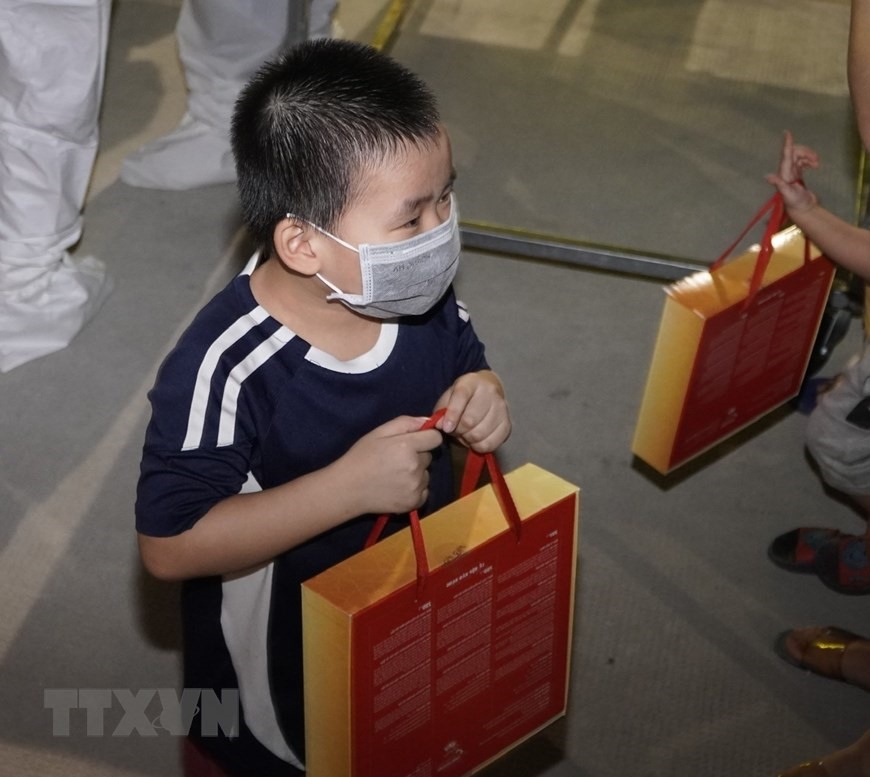 Một trẻ em tại Khu điều trị Bệnh viện dã chiến Thới Hòa, thị xã Bến Cát, tỉnh Bình Dương được tặng quà bánh Trung Thu. (Ảnh: TTXVN)