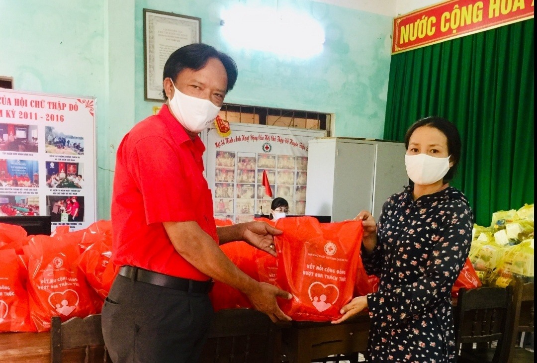 Cán bộ Hội Chữ thập đỏ xã Triệu Ái nhận quà để về trao cho người dân bị ảnh hưởng COVID-19 tại địa phương- Ảnh: M.L