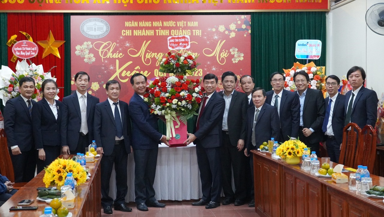 Chủ tịch UBND tỉnh Võ Văn Hưng tặng hoa chúc mừng Ngân hàng Nhà nước Chi nhánh tỉnh Quảng Trị - Ảnh: T.T