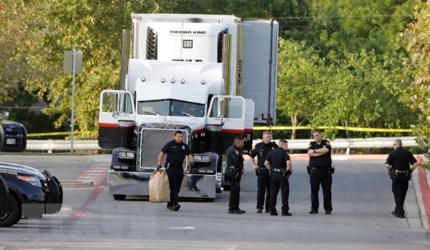 Lực lượng thực thi pháp luật Mỹ điều tra tại hiện trường phát hiện thi thể người nhập cư trong một xe tải ở San Antonio, bang Texas. (Ảnh: CNN/TTXVN)