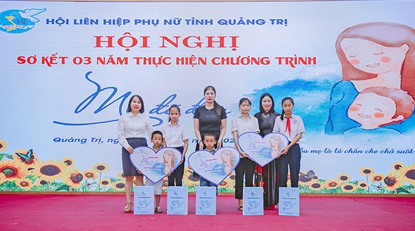 Chị Hồng Shurany (thứ 2 bên phải sang) cùng các con được đỡ đầu tại hội nghị sơ kết 3 năm thực hiện Chương trình “Mẹ đỡ đầu” - Ảnh: THU THẢO