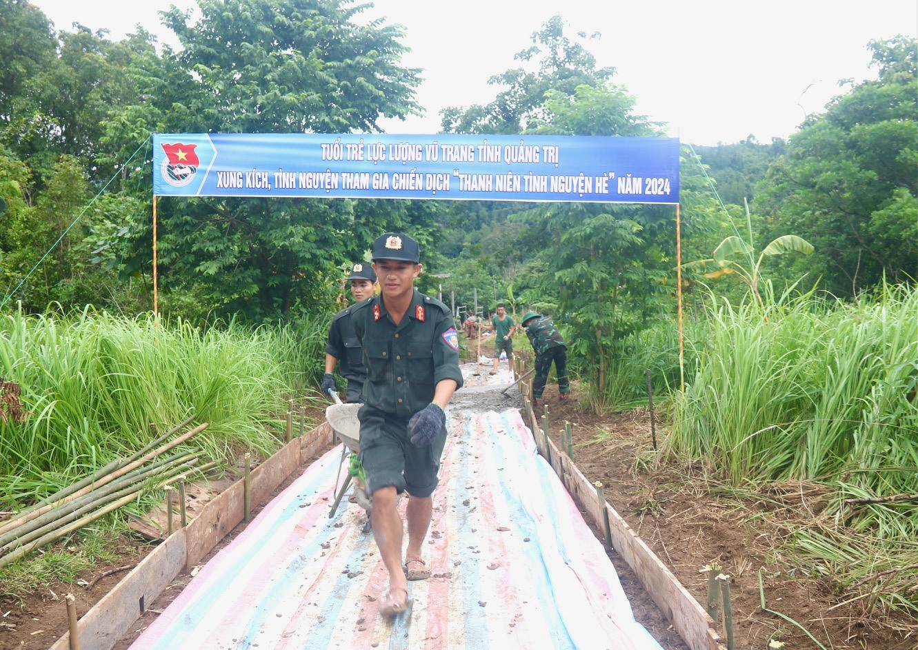 Đoàn viên thanh niên thuộc lực lượng vũ trang tỉnh tham gia xây dựng đường bê tông nông thôn tại thôn Ra Ly Rào, xã Hướng Sơn - Ảnh: N.B