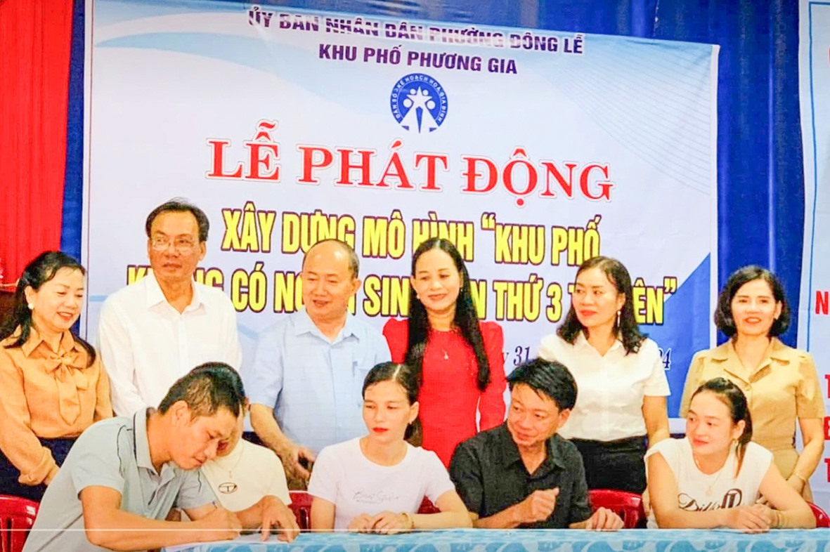 Đại diện các cặp vợ chồng trong độ tuổi sinh đẻ ở khu phố Phương Gia, phường Đông Lễ, TP. Đông Hà ký cam kết không sinh con thứ 3 trở lên -Ảnh: N.T